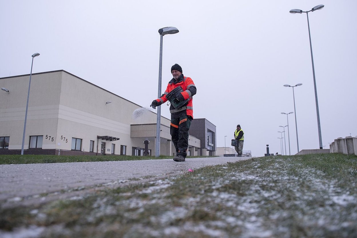 People walking on a cleared, treated winter path